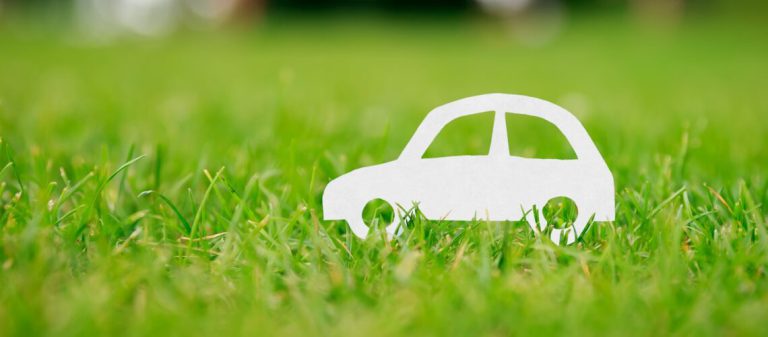 Paper,Cut,Of,Car,On,Green,Grass