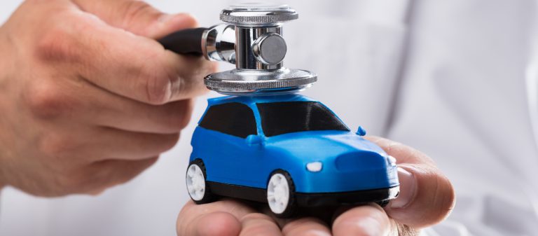 Close-up,Of,A,Doctor's,Hand,Examining,Blue,Car