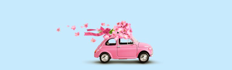 Pink,Toy,Car,With,Bouquet,Of,Flowers,On,A,Roof