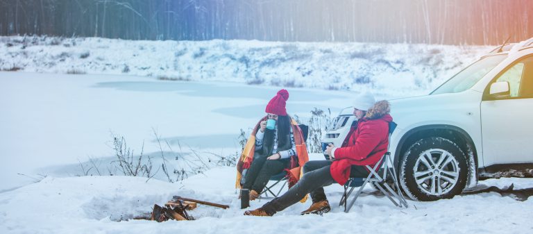 Man,With,Woman,Sitting,On,Chairs,Near,Camp,Fire,In