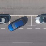Drone,,Top,Down:,Flying,Above,A,Shiny,Blue,Car,Driving