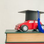 Graduation,Cap,On,Wooden,Car,Over,The,Pile,Of,Books