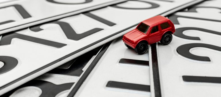 Close-up,Of,Car,License,Plates,With,A,Toy,Car,,The