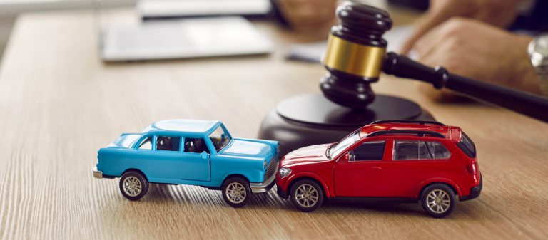 Little,Crashed,Autos,On,Table,In,Courtroom.,Gavel,And,Two